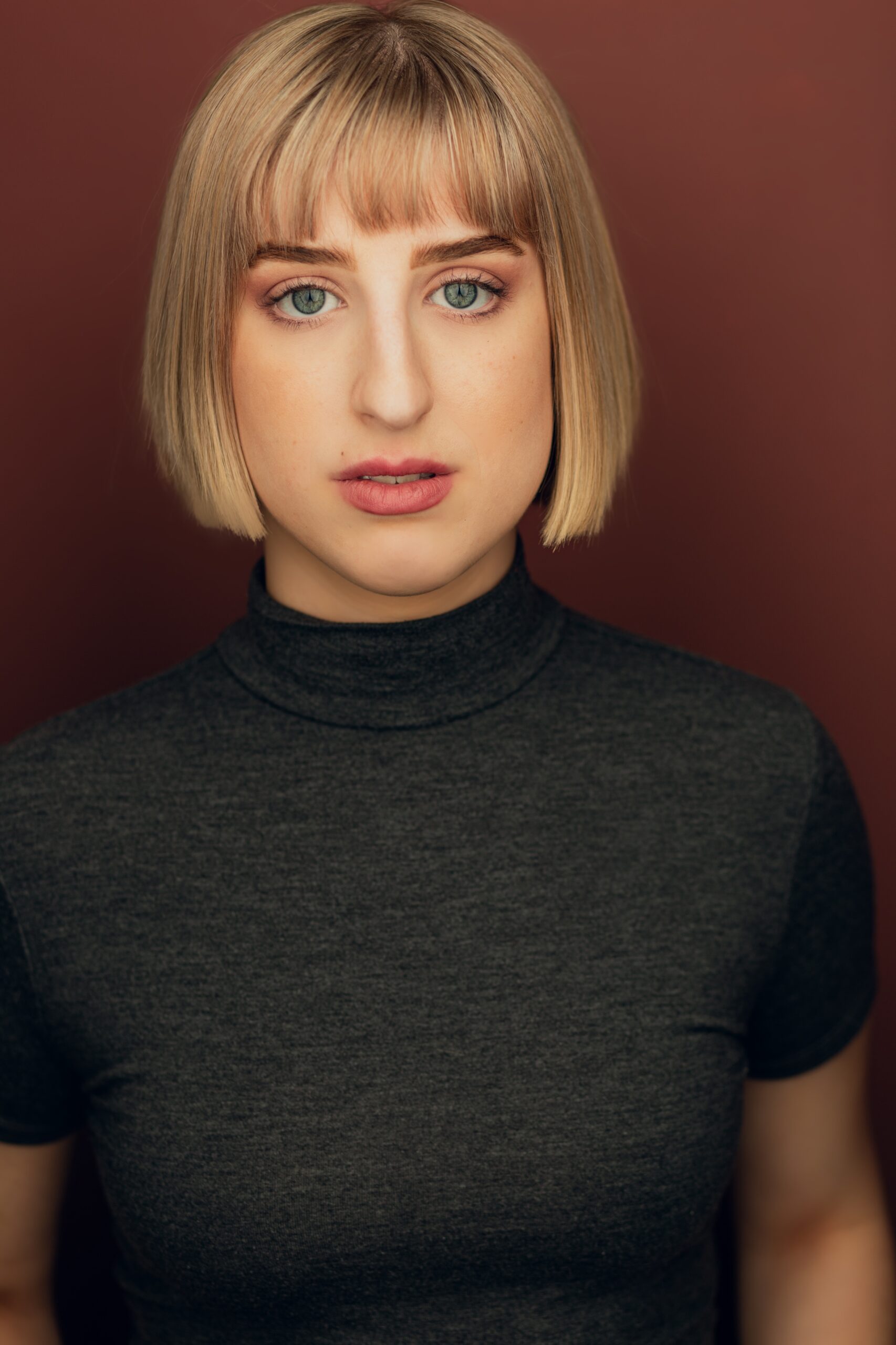 Headshot of Emily Madison in a black sweater